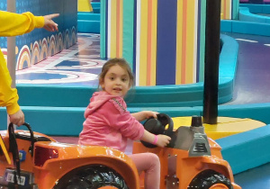 Zdjęcie przedstawia dziewczynkę w aucie